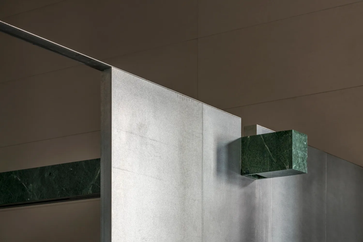 Modern interior design featuring a combination of marble and concrete materials.