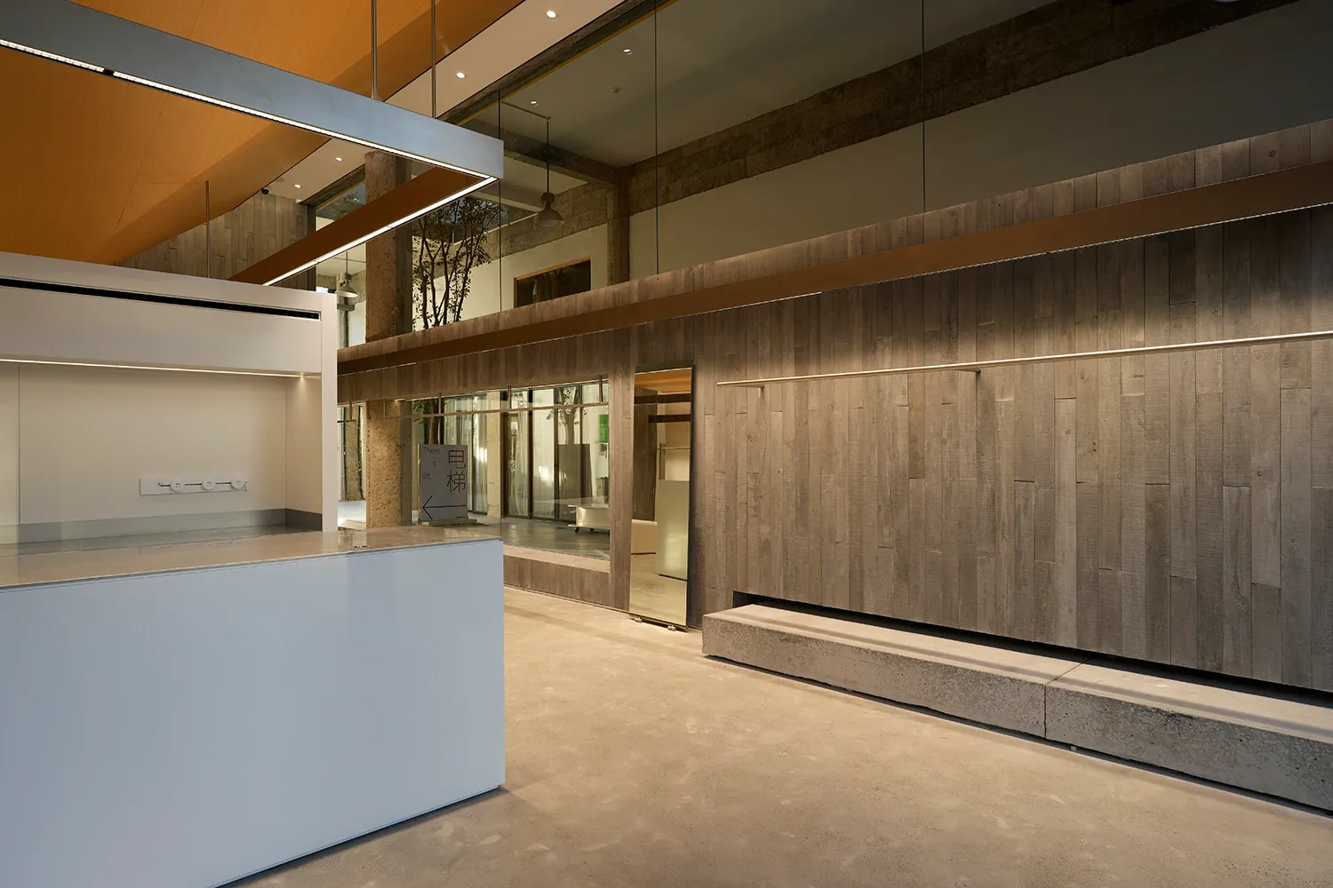 A modern lobby featuring concrete walls and a minimalist design.
