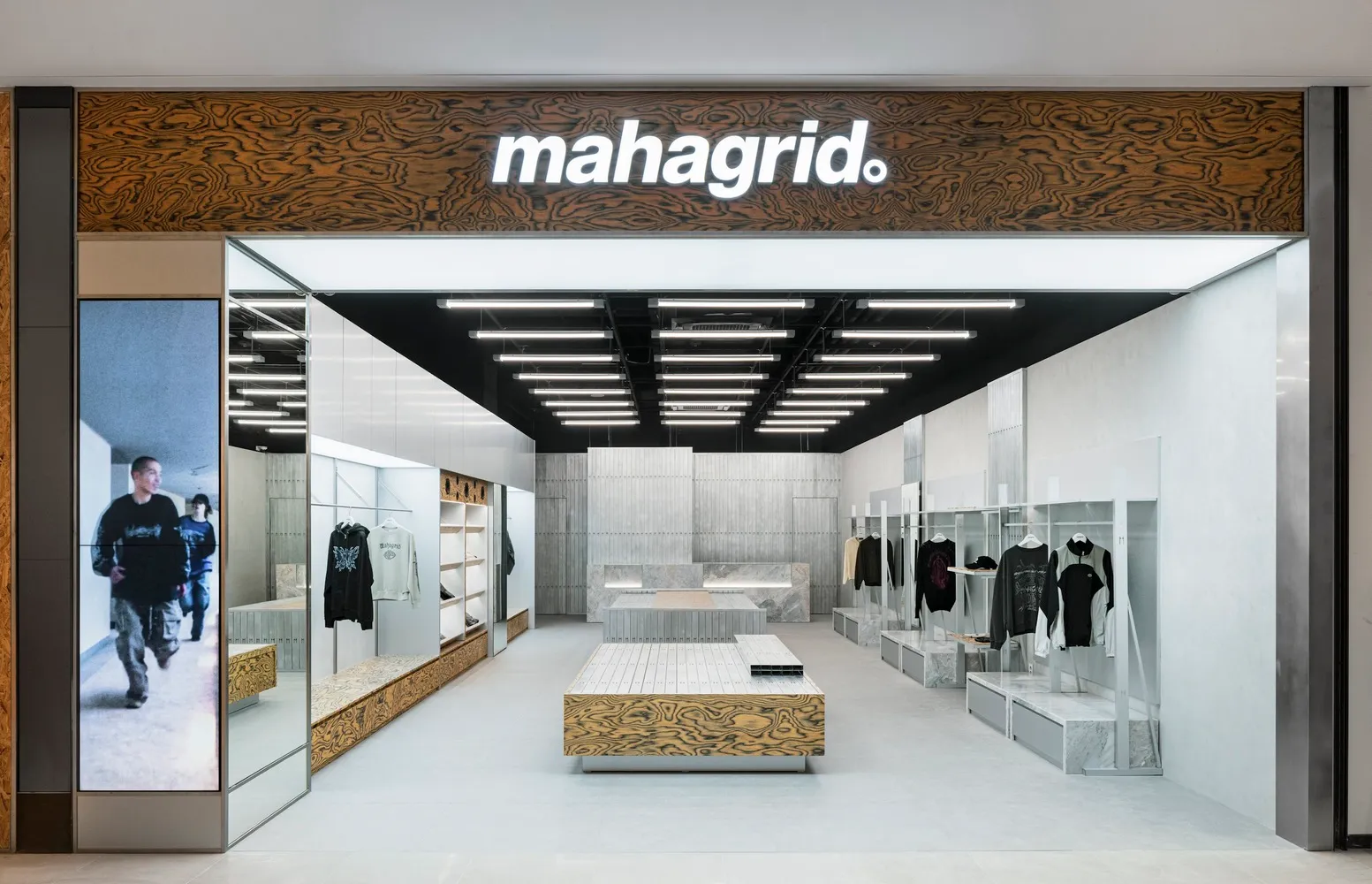 A modern minimalist retail storefront showcasing concrete and glass materials.