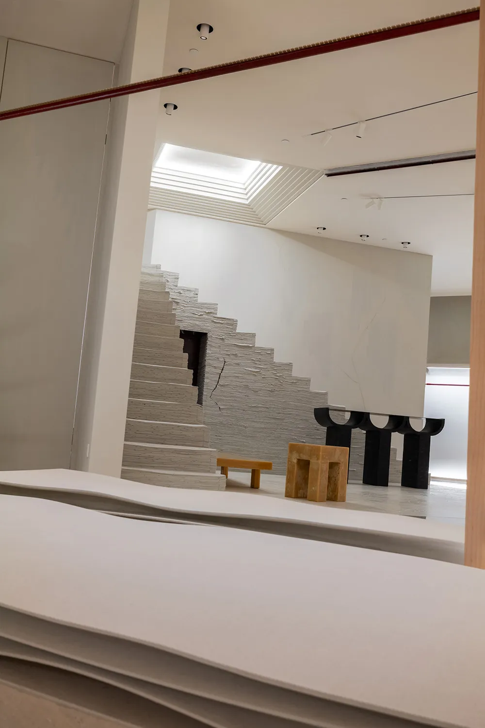 A minimalist modern interior design featuring a concrete staircase