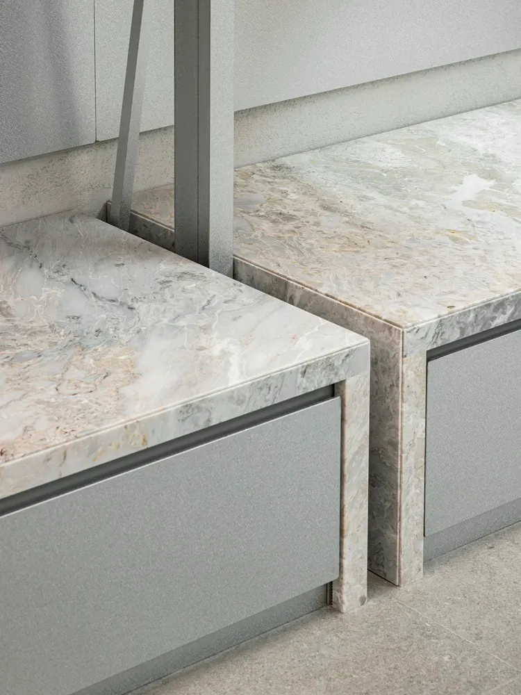 Modern kitchen cabinets with marble countertops.