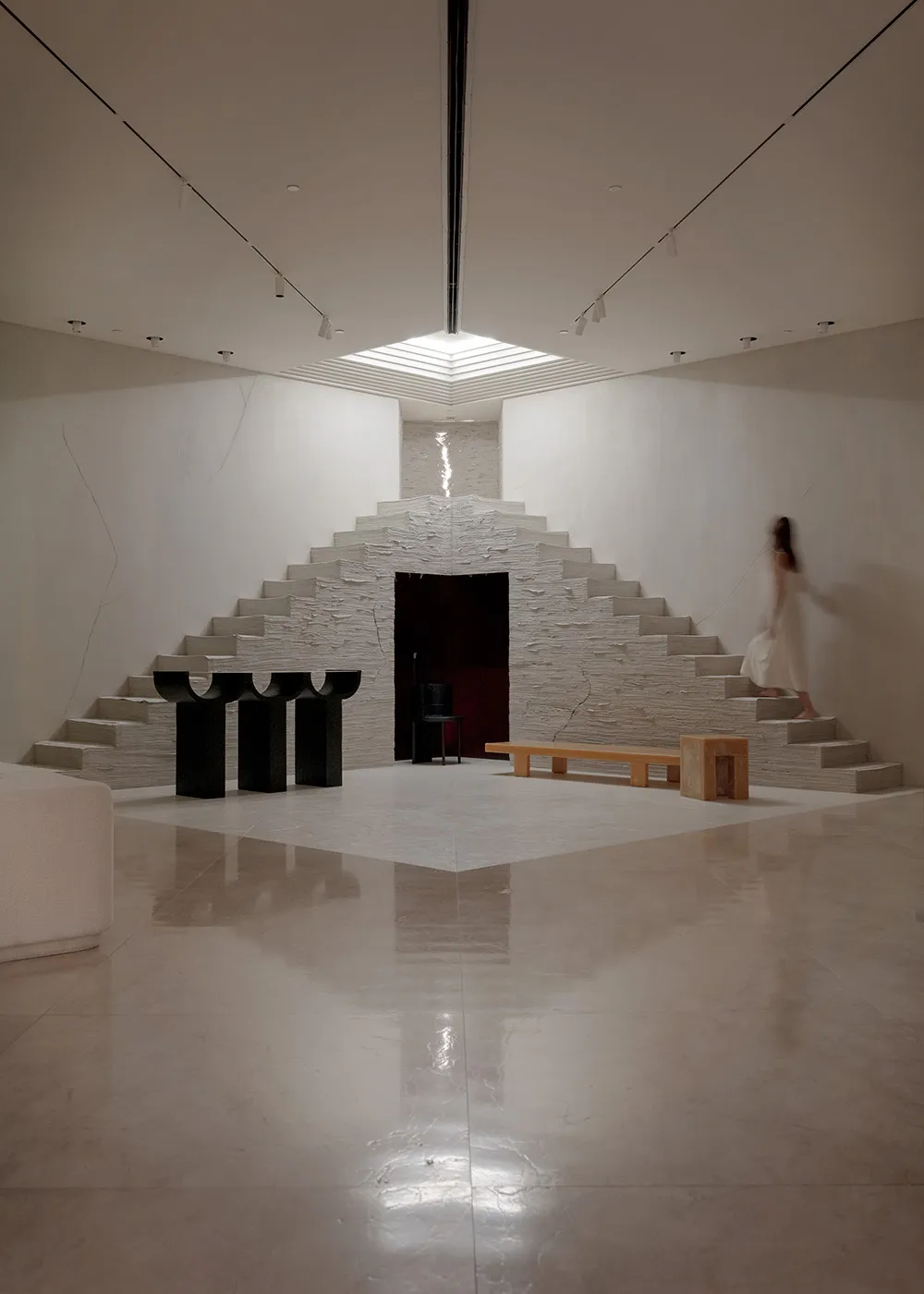 A minimalist interior space featuring concrete walls and steps.