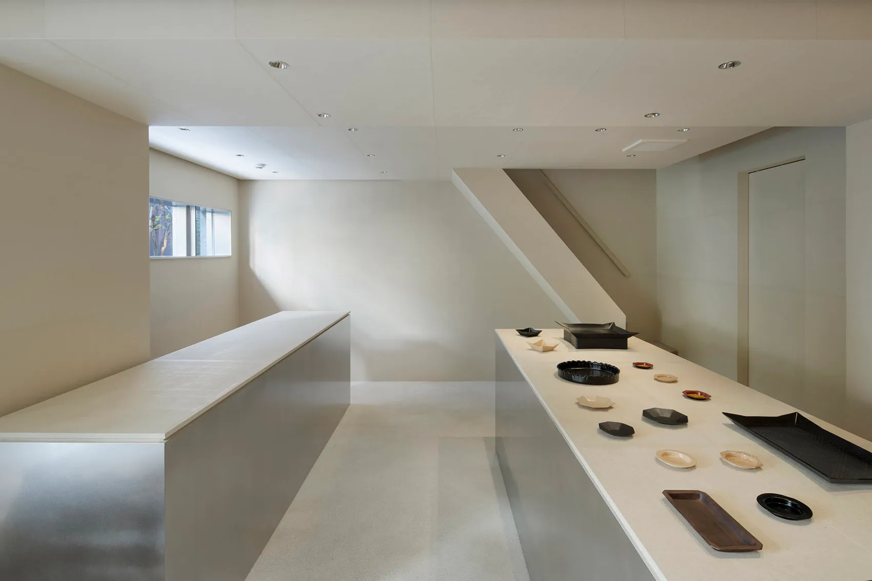 A minimalist interior space with concrete walls and floors.