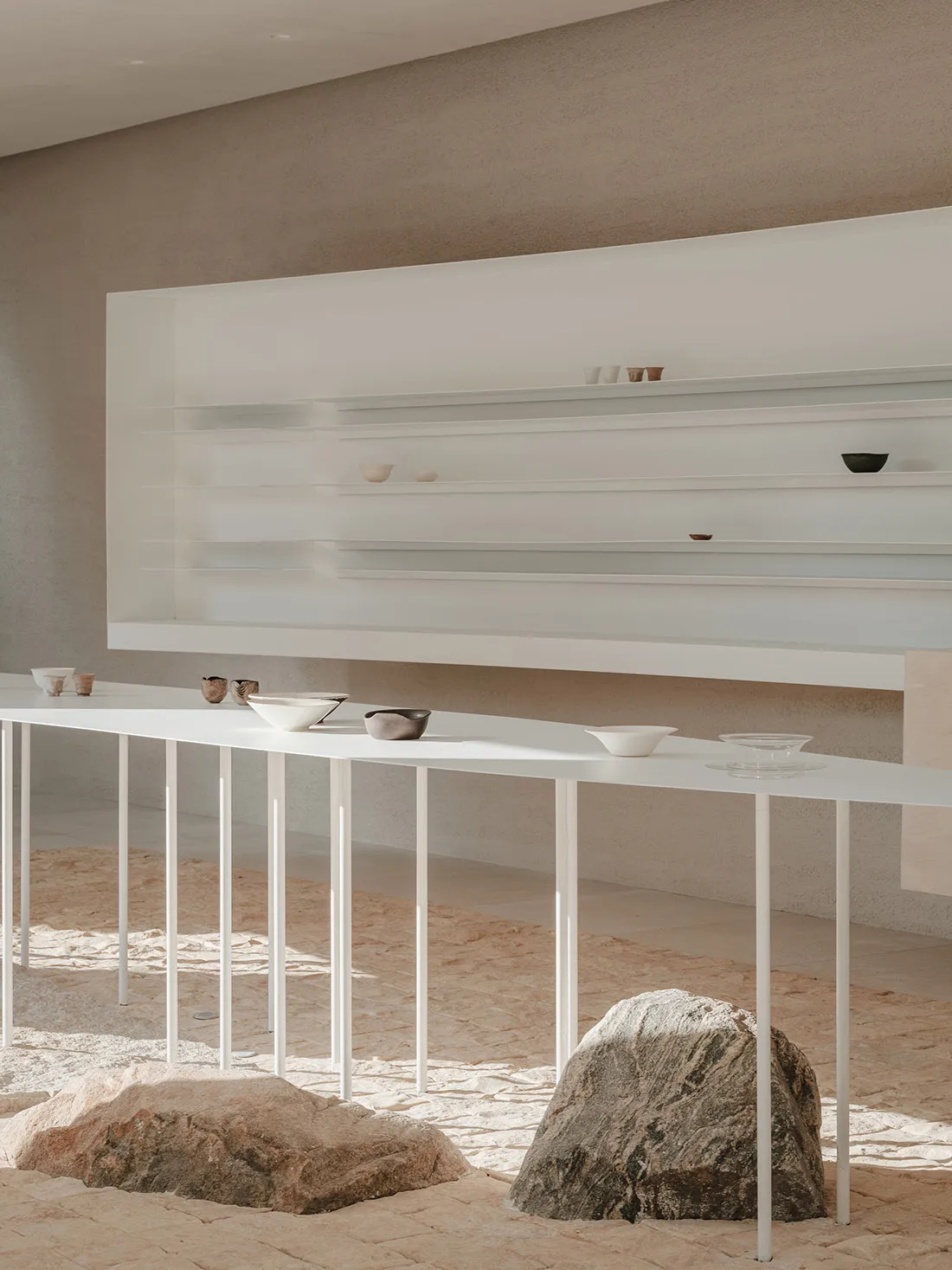A minimalist commercial design showcasing sleek white surfaces and a combination of materials.