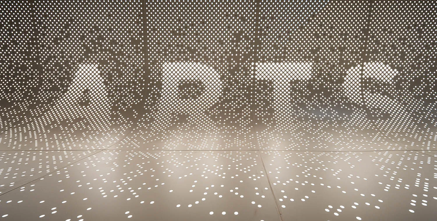 A minimalist interior design featuring a metallic mesh material