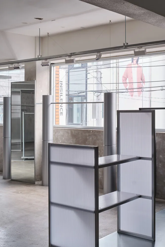 Industrial-style interior with metal shelving system and minimalist design elements.