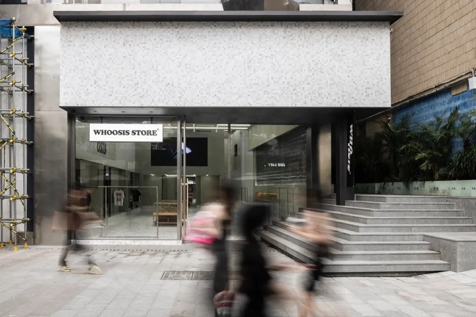 A modern storefront with a glass facade in an urban setting.