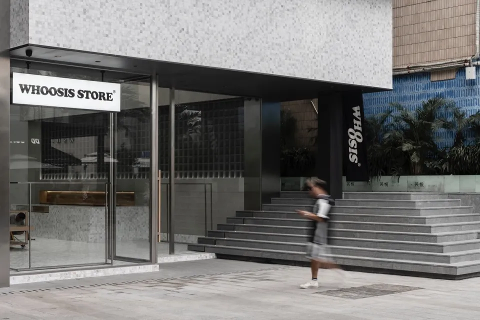 A modern retail storefront with glass and concrete features.