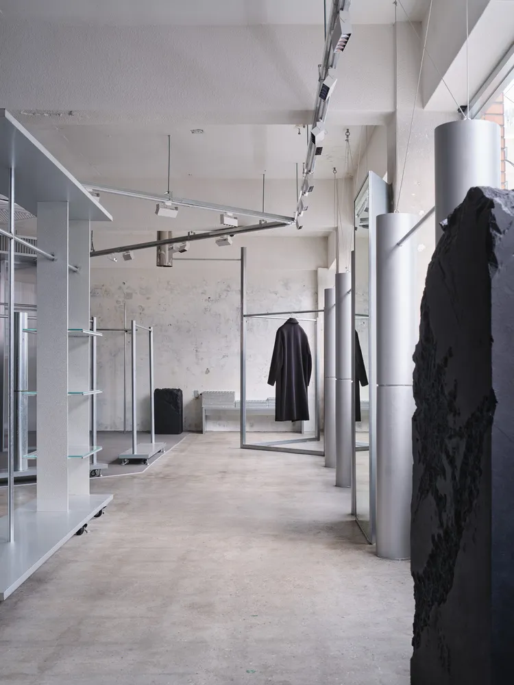 Modern shopping center interior with concrete flooring and minimalist design.