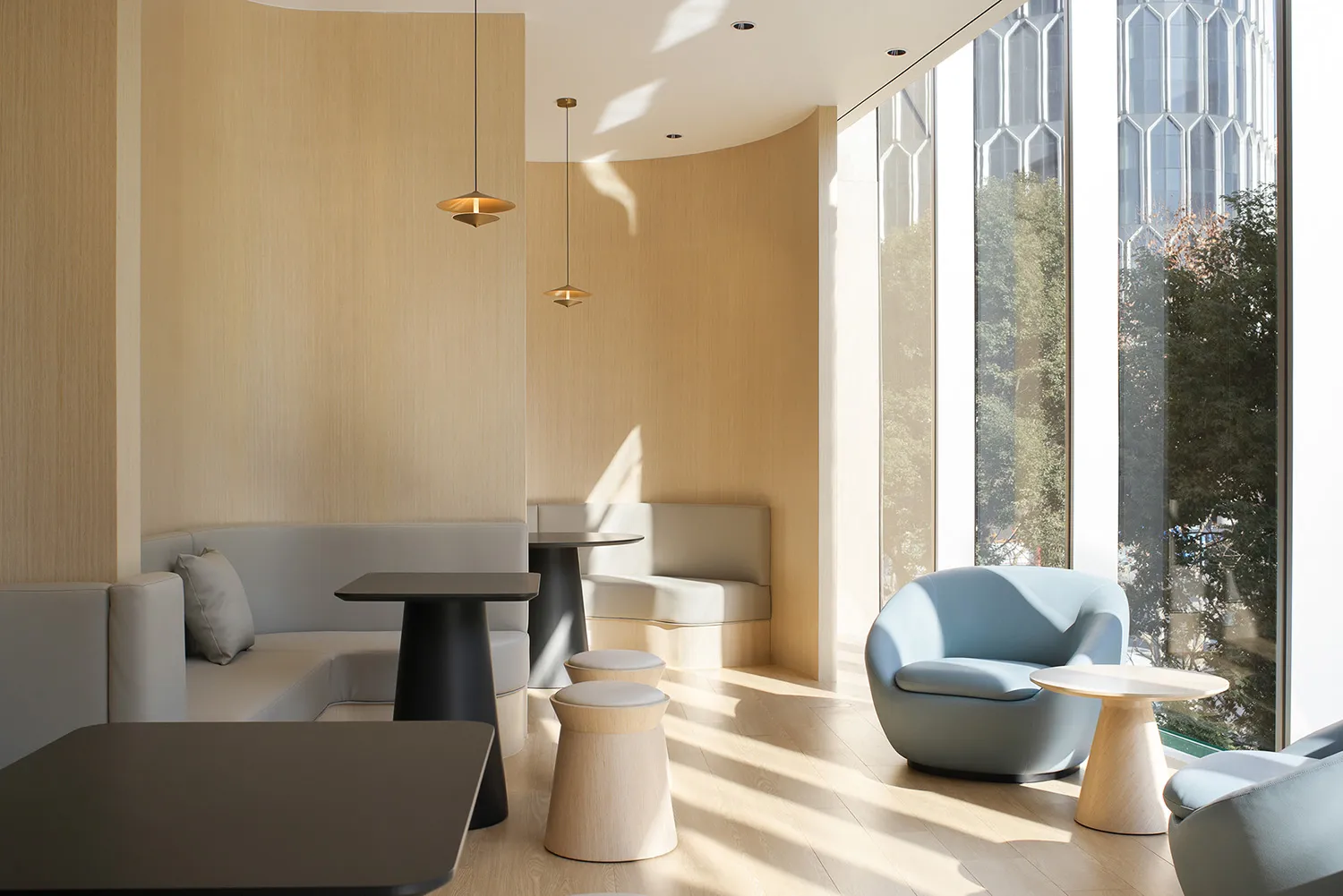 Modern cafe interior with neutral-colored materials and contemporary furniture.