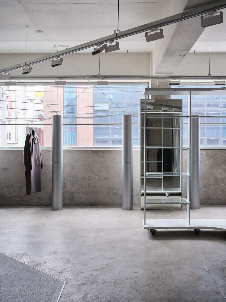 An industrial interior space with metallic lighting fixtures and minimalist design elements.