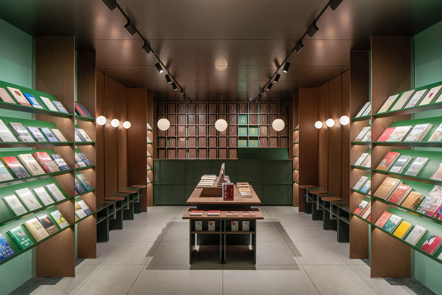 A modern bookstore with wooden shelves and green wall panels
