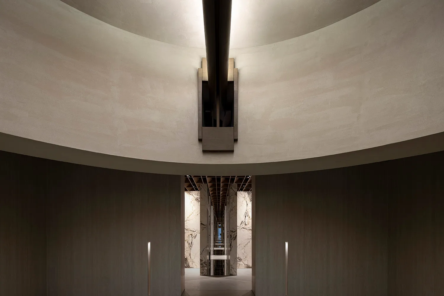 Modern interior featuring concrete columns and a circular ceiling.