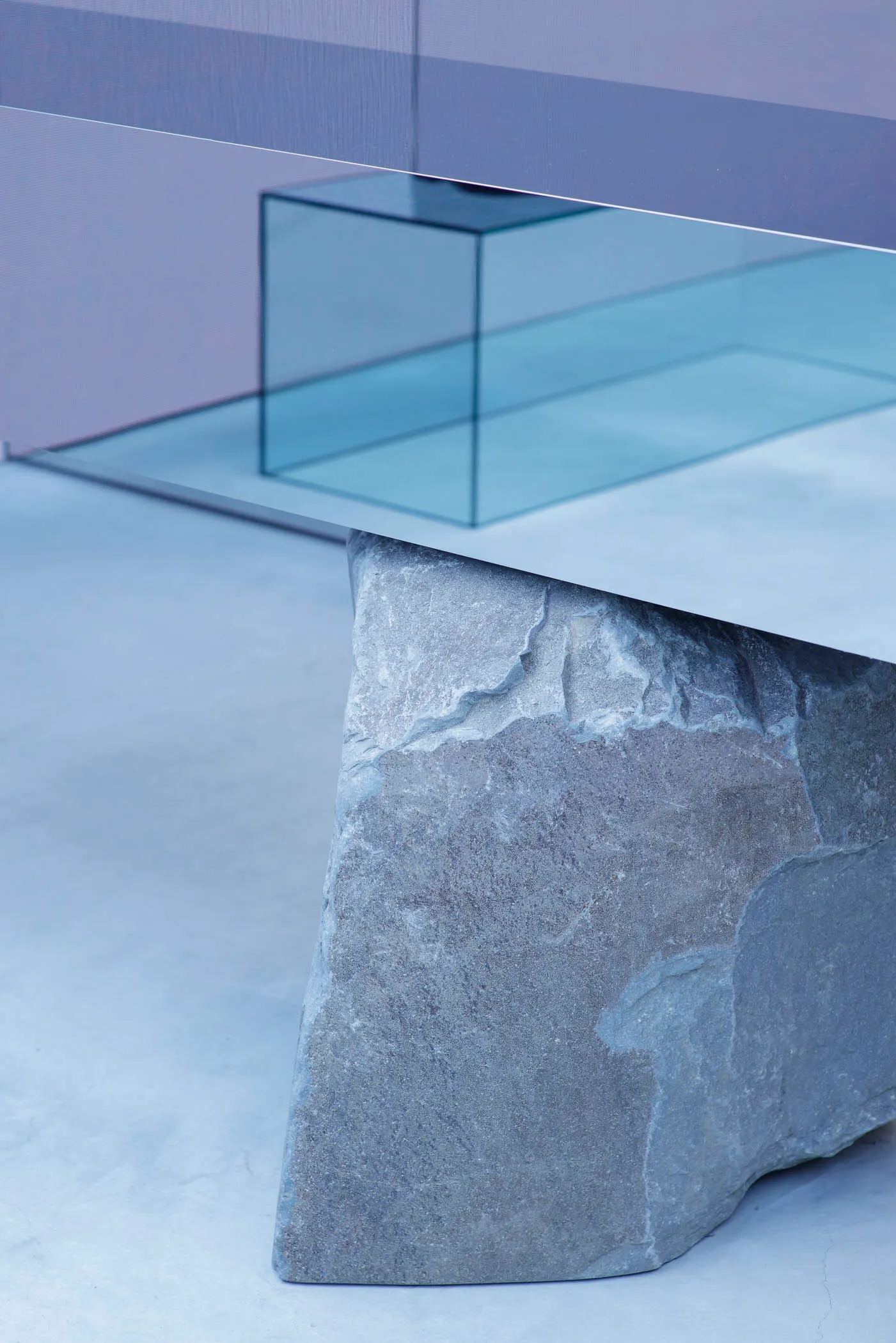 A modern stone table with a minimalist design in a contemporary interior setting.