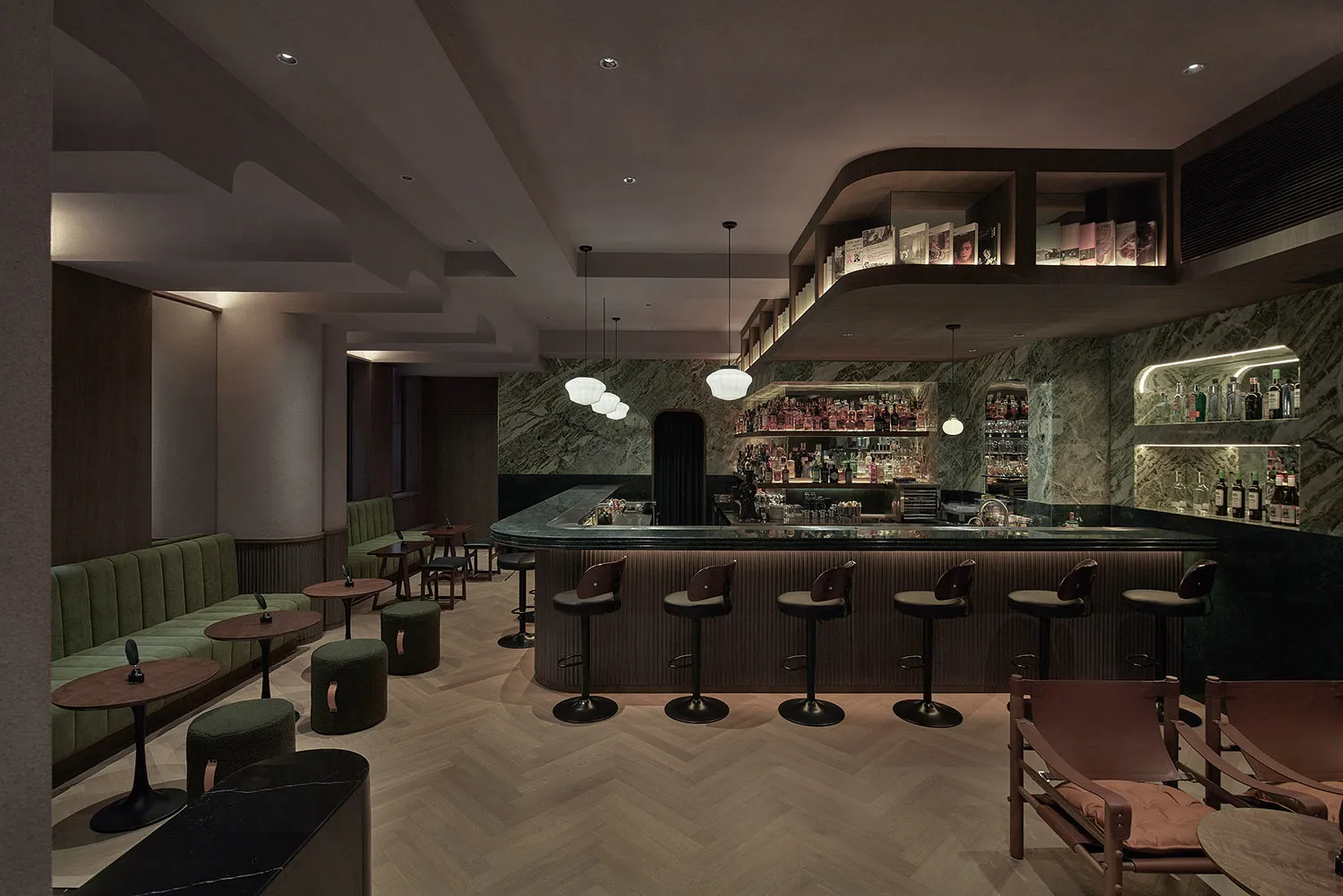 A stylish modern bar with marble countertops and seating arrangements