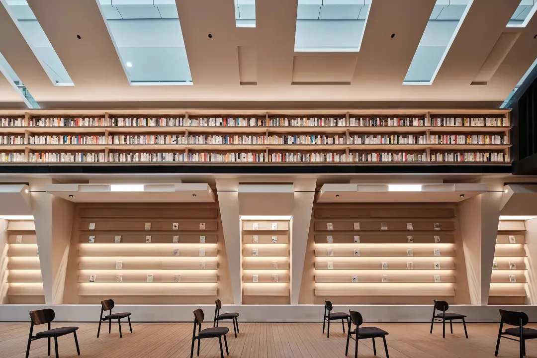Library interior with wooden bookshelves filled with books.