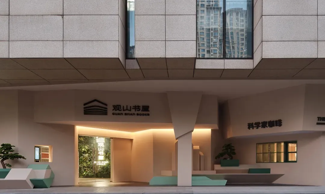An entrance to a modern lobby with a concrete facade.