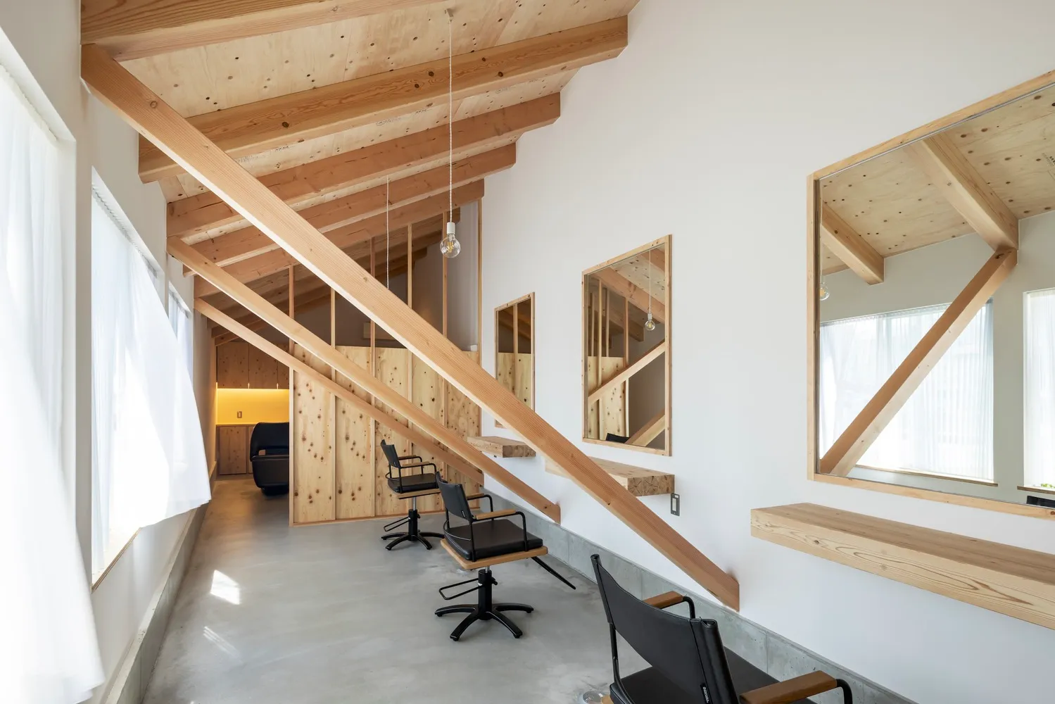 Minimalist commercial interior featuring wooden beams and chairs.