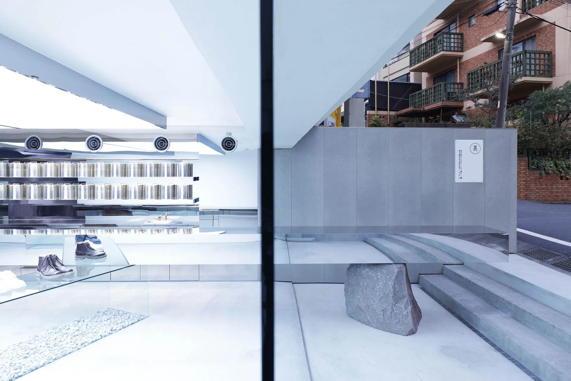 A modern retail space featuring glass and concrete materials with minimalist design elements.
