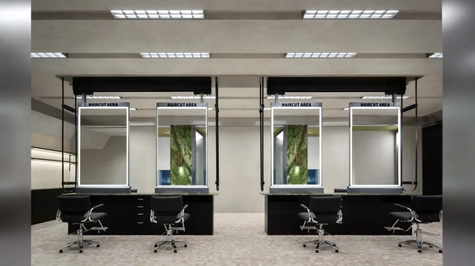 An interior design of a hair salon featuring modern metal-framed mirrors.
