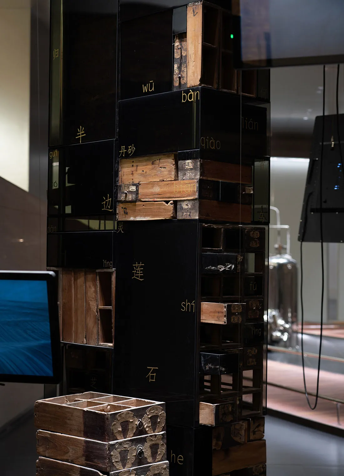 A modular, industrial-style installation composed of various metal boxes and crates with Chinese characters.