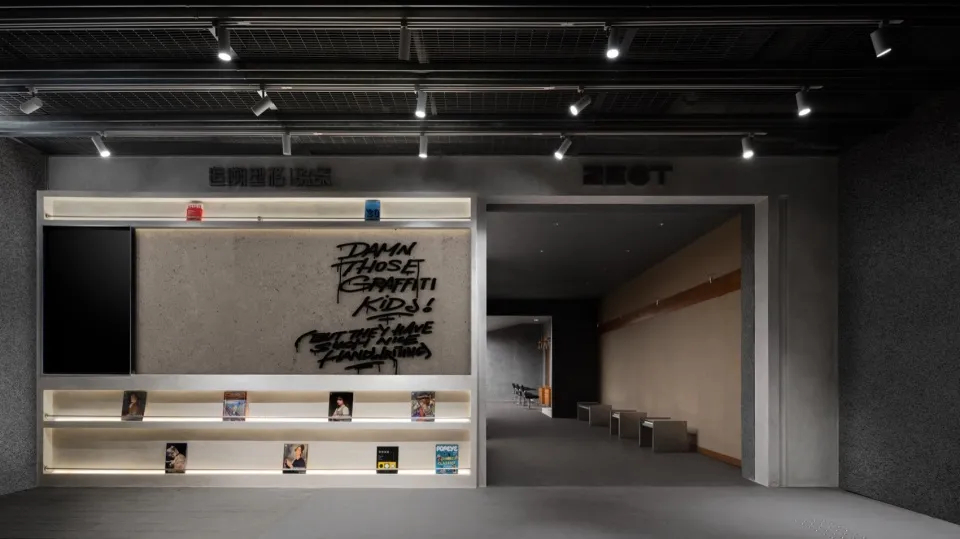 Industrial-style retail storefront with concrete walls and black metal accents.