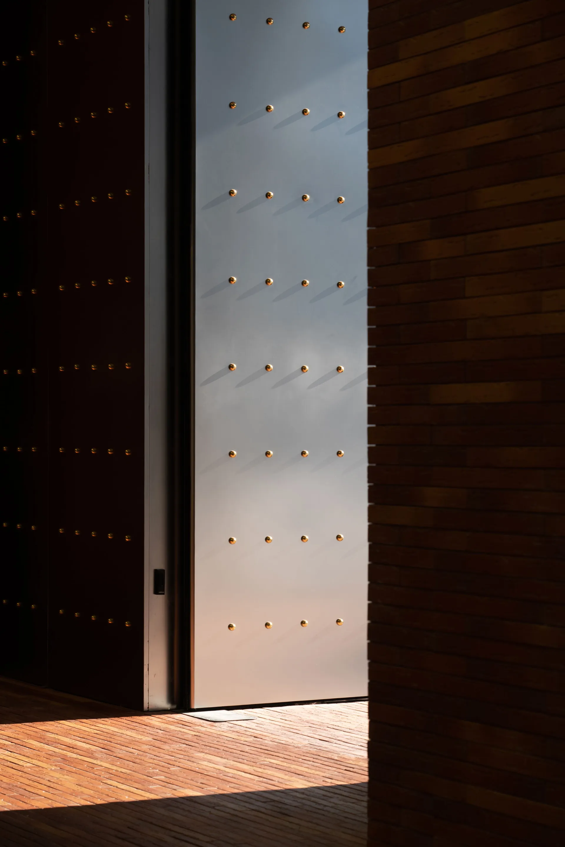 A modern interior featuring wooden walls and metallic accents.