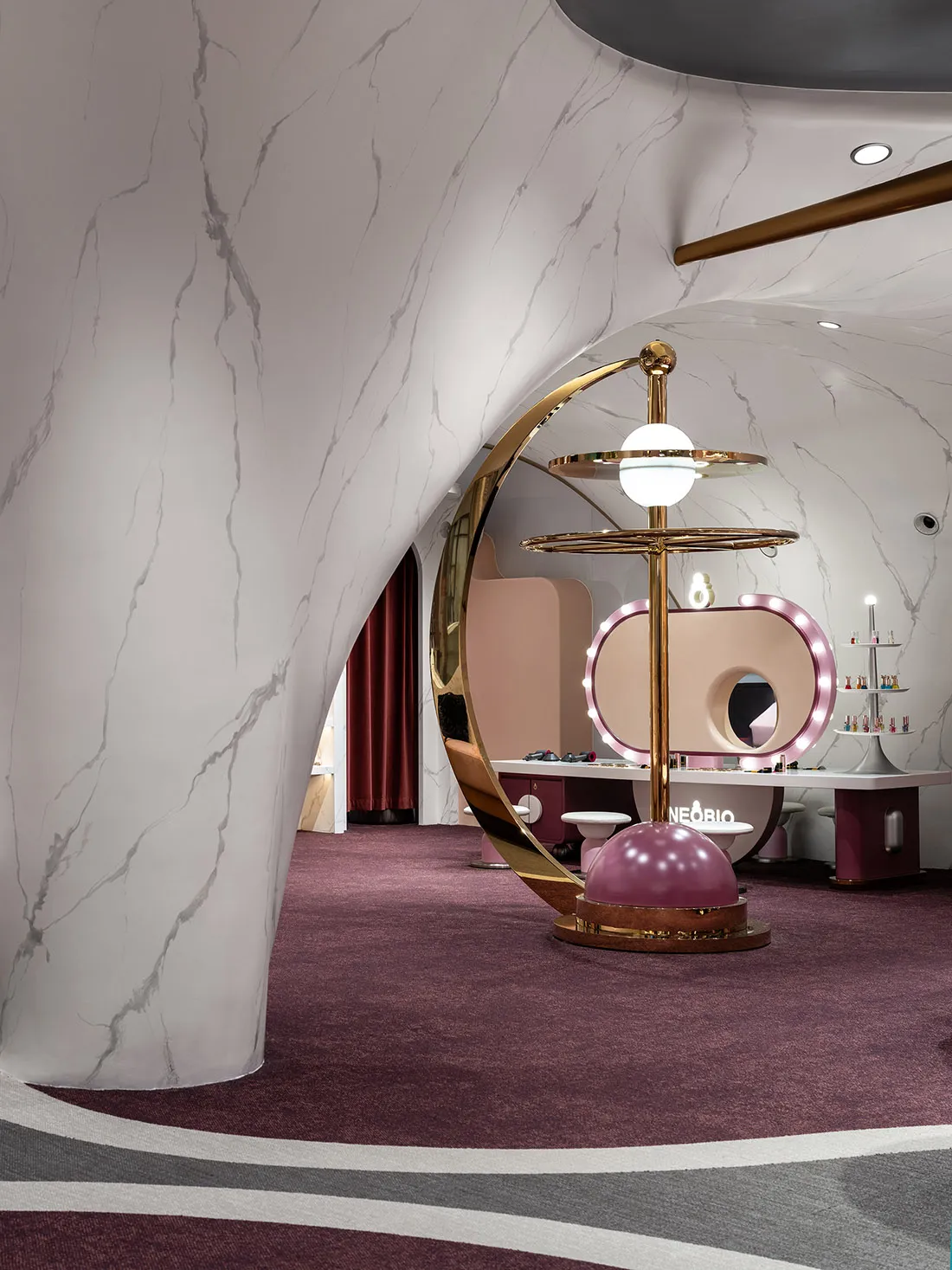 A modern, visually striking cosmetics shop with marble and gold materials.