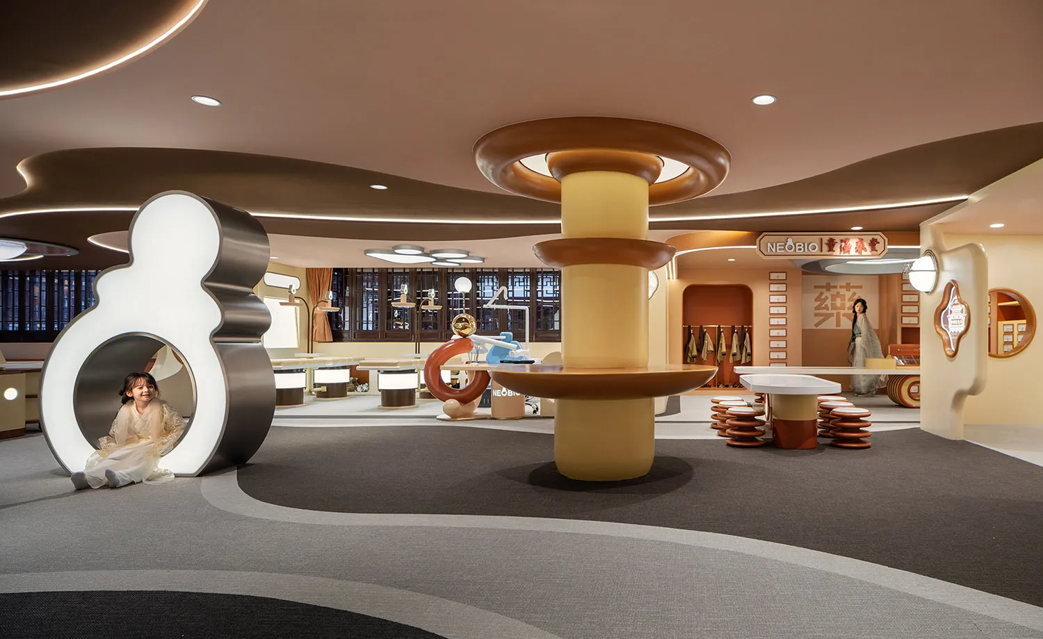 A modern playroom with wooden furniture and playful geometric shapes.