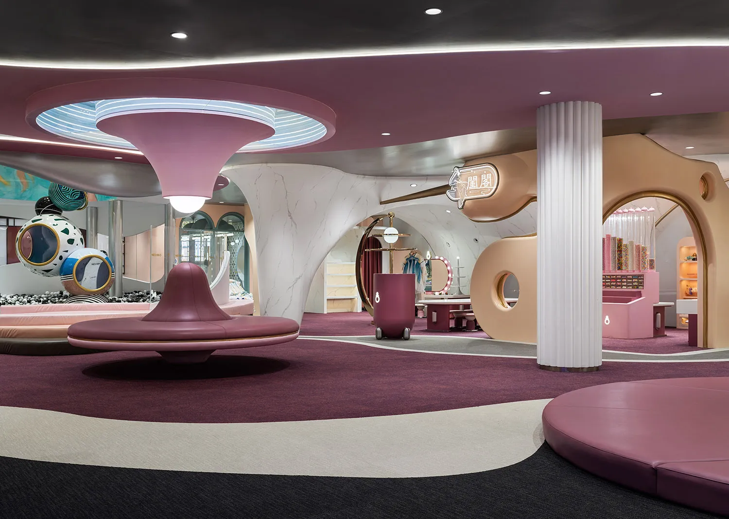 Modern retail store interior with curved pink soffit and soft furnishings