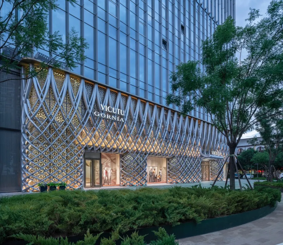 Modern retail storefront featuring an open-air design with metallic lattice facade.