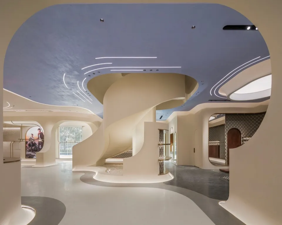 A modern retail space featuring white concrete elements and curved architectural details.