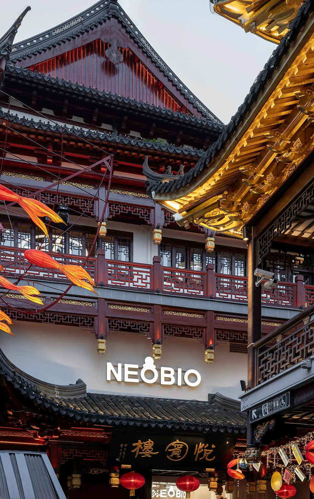 A traditional Chinese storefront with ornate wooden architecture, glass windows, and metal railings.