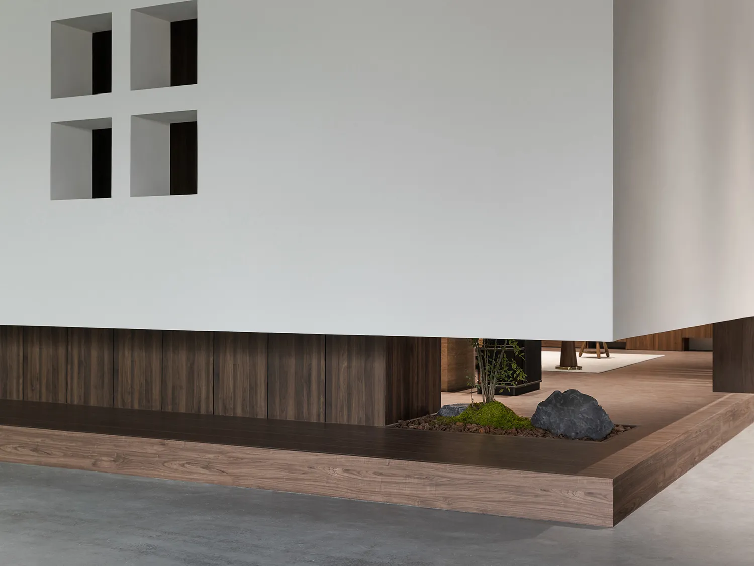A modern office space with wooden flooring and concrete accents.