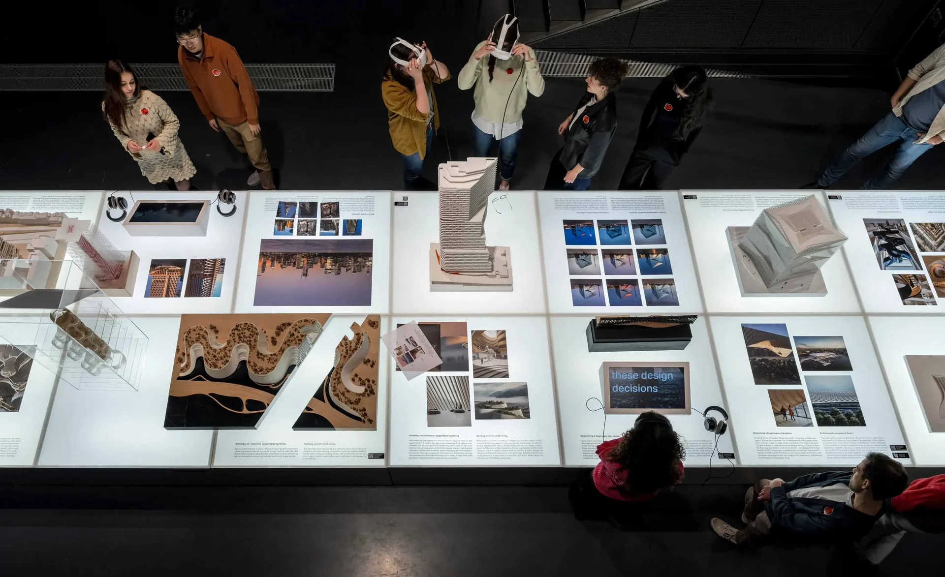 Architecture installation exhibition with models and images showcasing design decisions.
