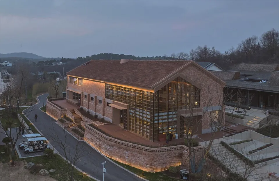 A modern building with a brick exterior during sunset