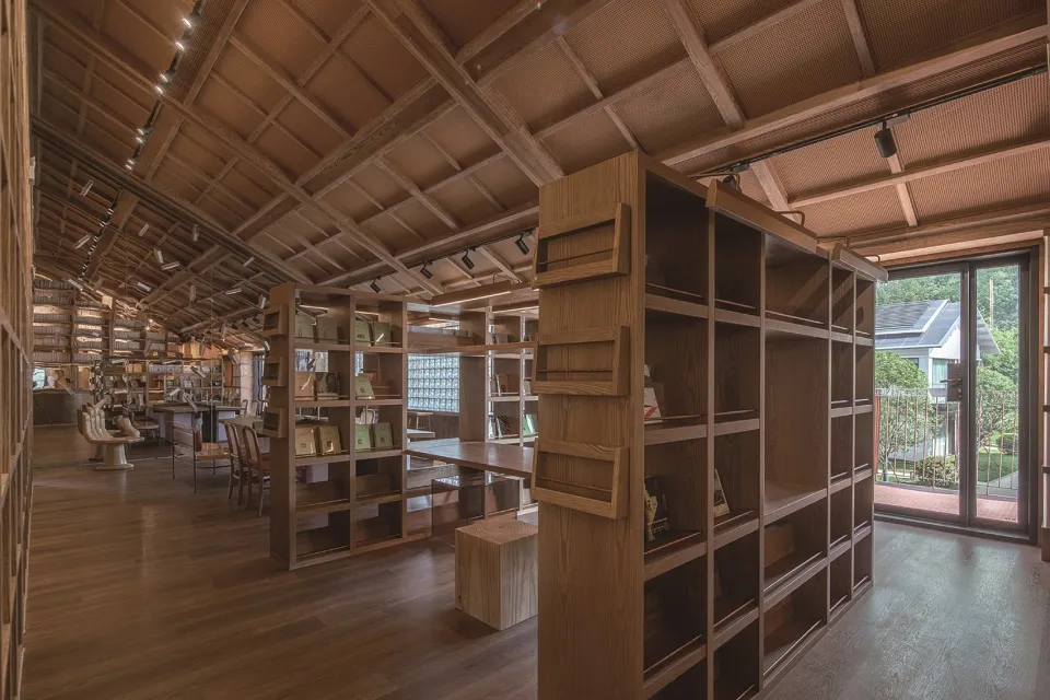 An image of a modern library interior with wooden shelves and floors.
