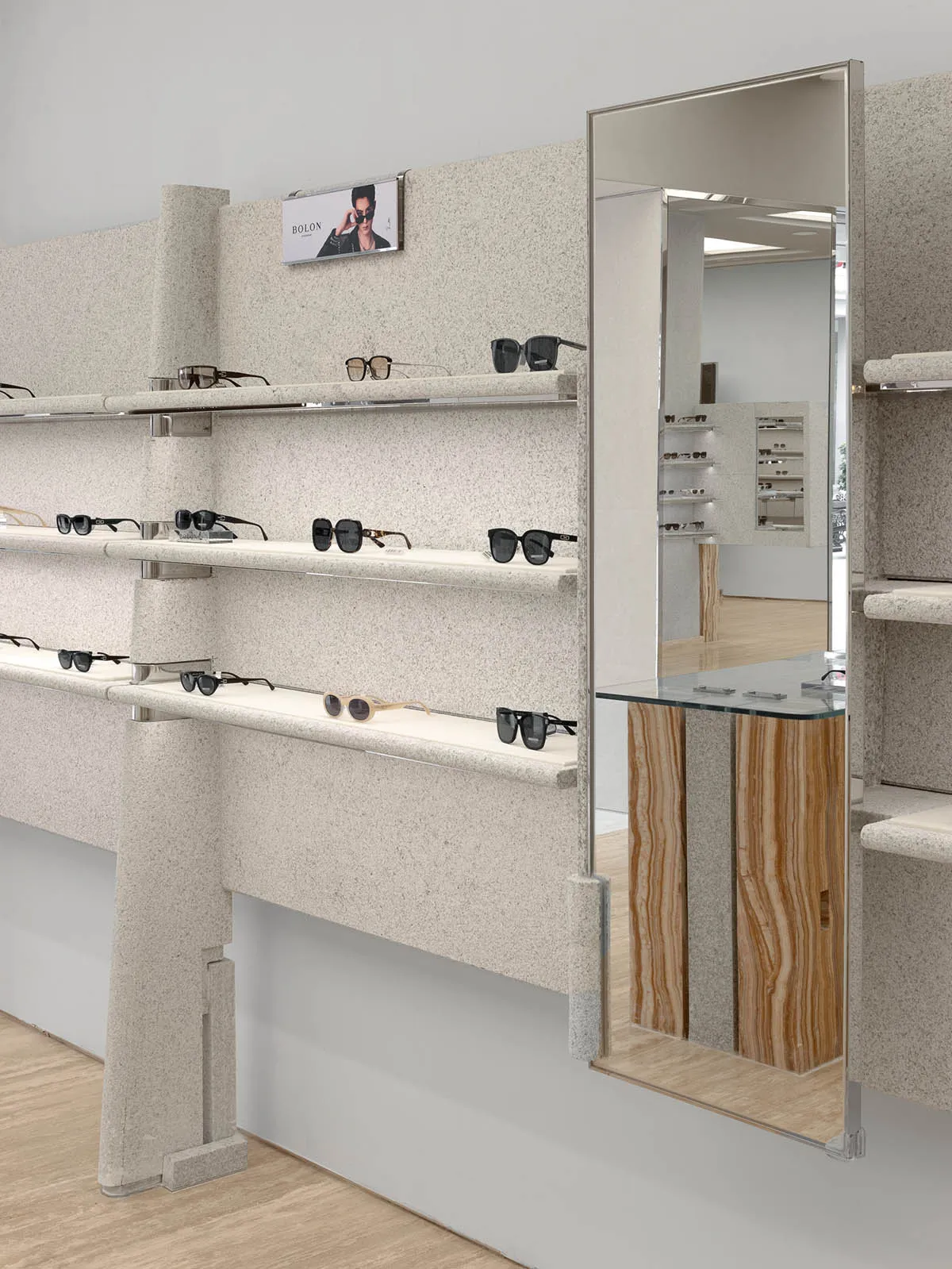 A modern retail display featuring granite shelves with glasses displayed