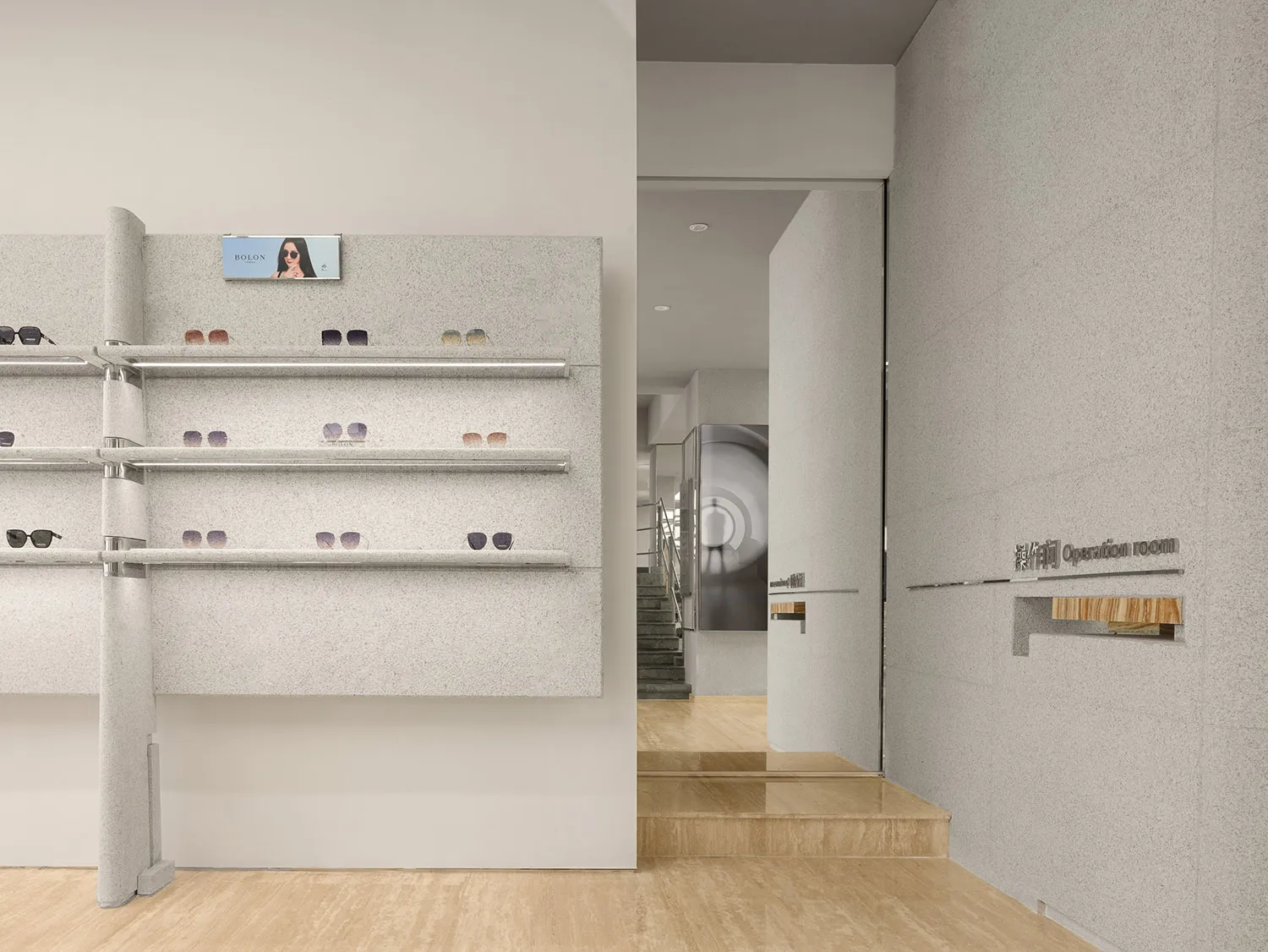 Modern storefront with concrete shelves displaying sunglasses.