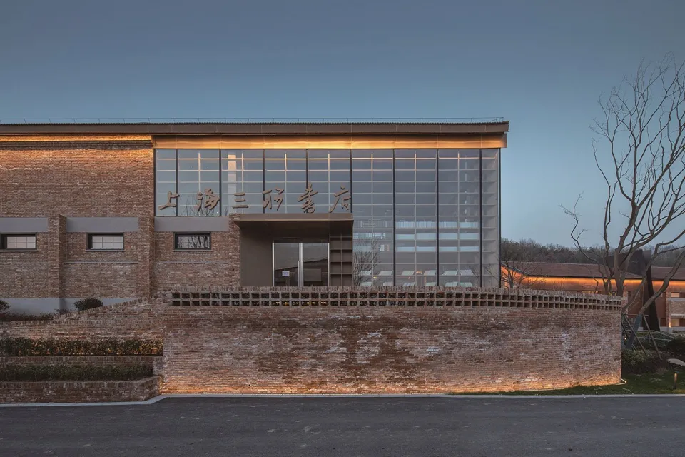 Modern storefront with brick wall and large glass windows.