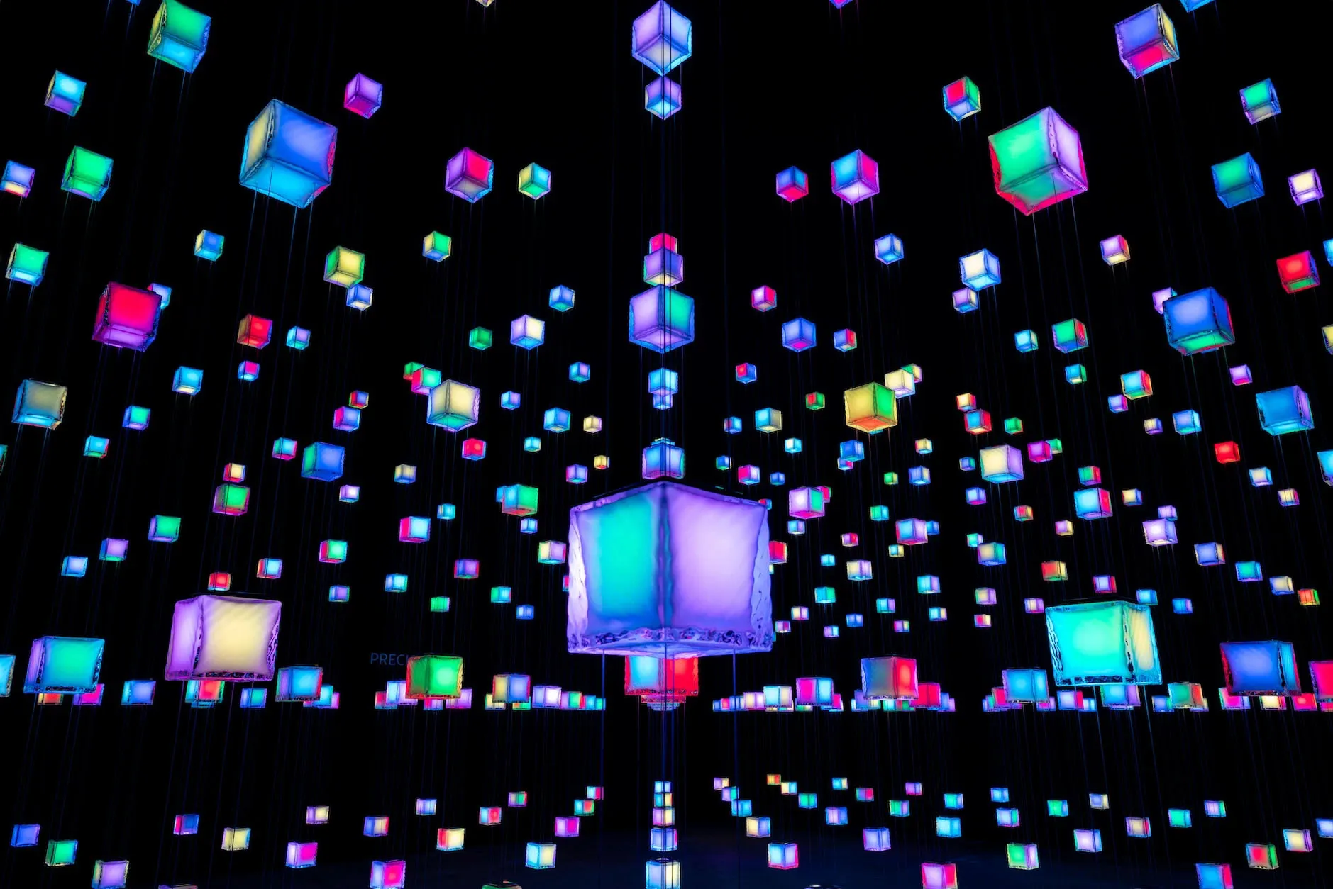 Colorful LED light installation featuring suspended cubes in a contemporary space.