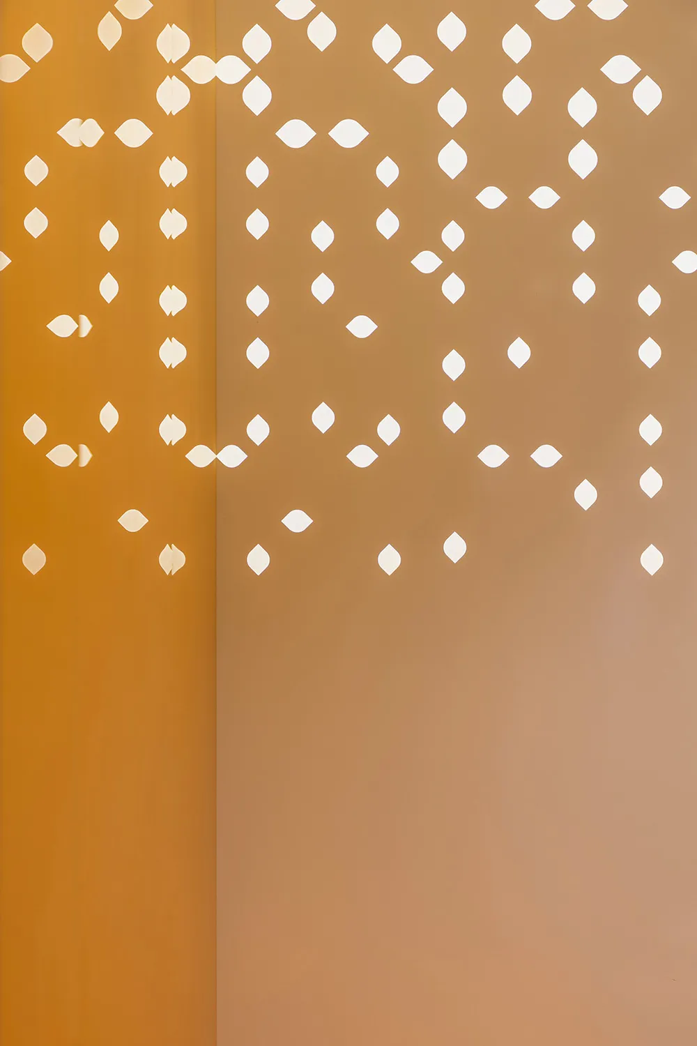A minimalist interior design featuring textured plywood with geometric cutouts.