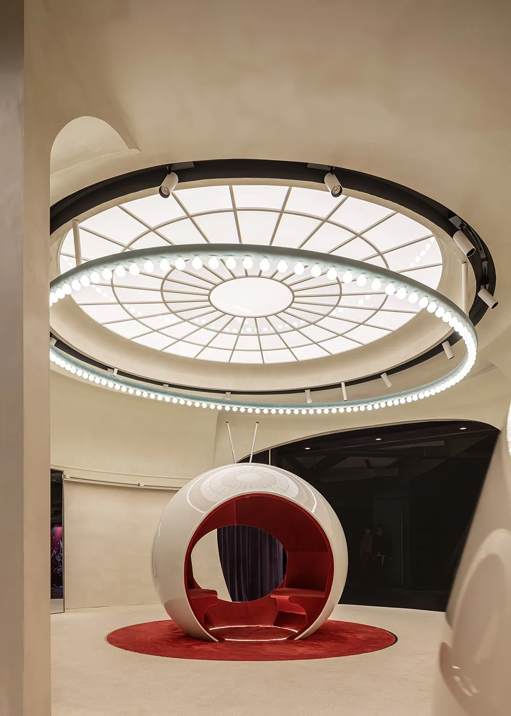 A sleek, metallic white chair in a modern coffee shop setting