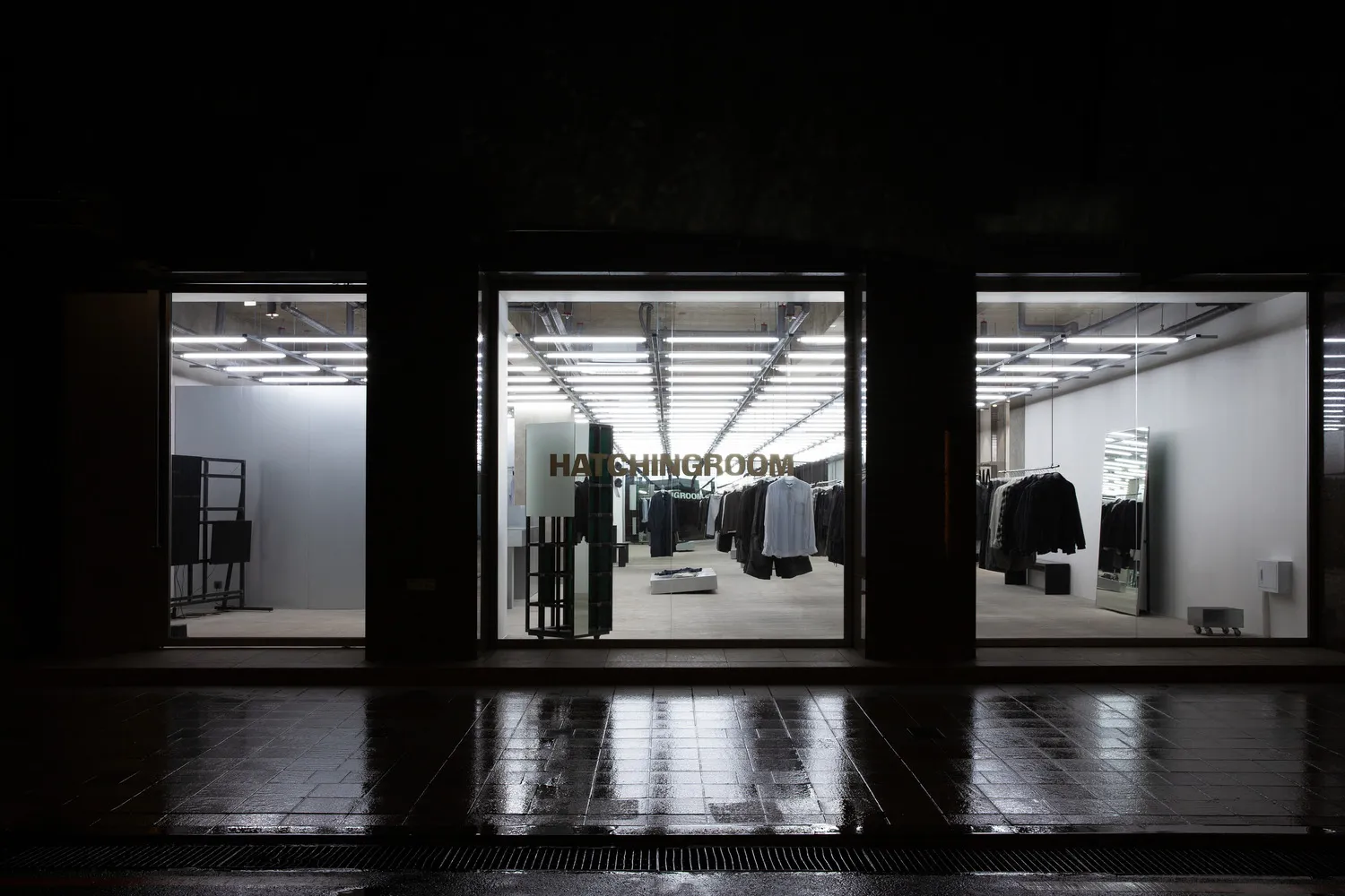Modern retail space featuring metal, glass, and concrete materials