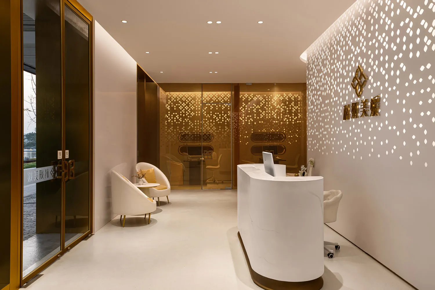 Modern interior design featuring a sleek, white marble reception desk, white armchairs with yellow accents, and a glass wall