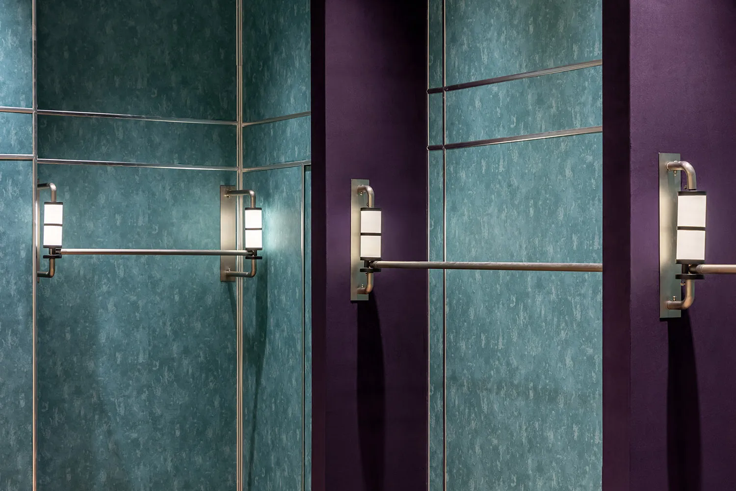Modern elevator interior featuring reflective mirror and metallic accents