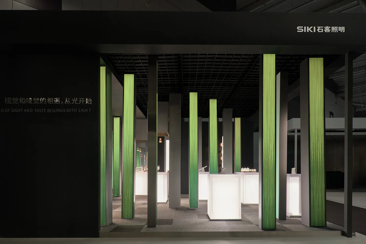 A minimalist exhibit stall featuring modern LED light columns.