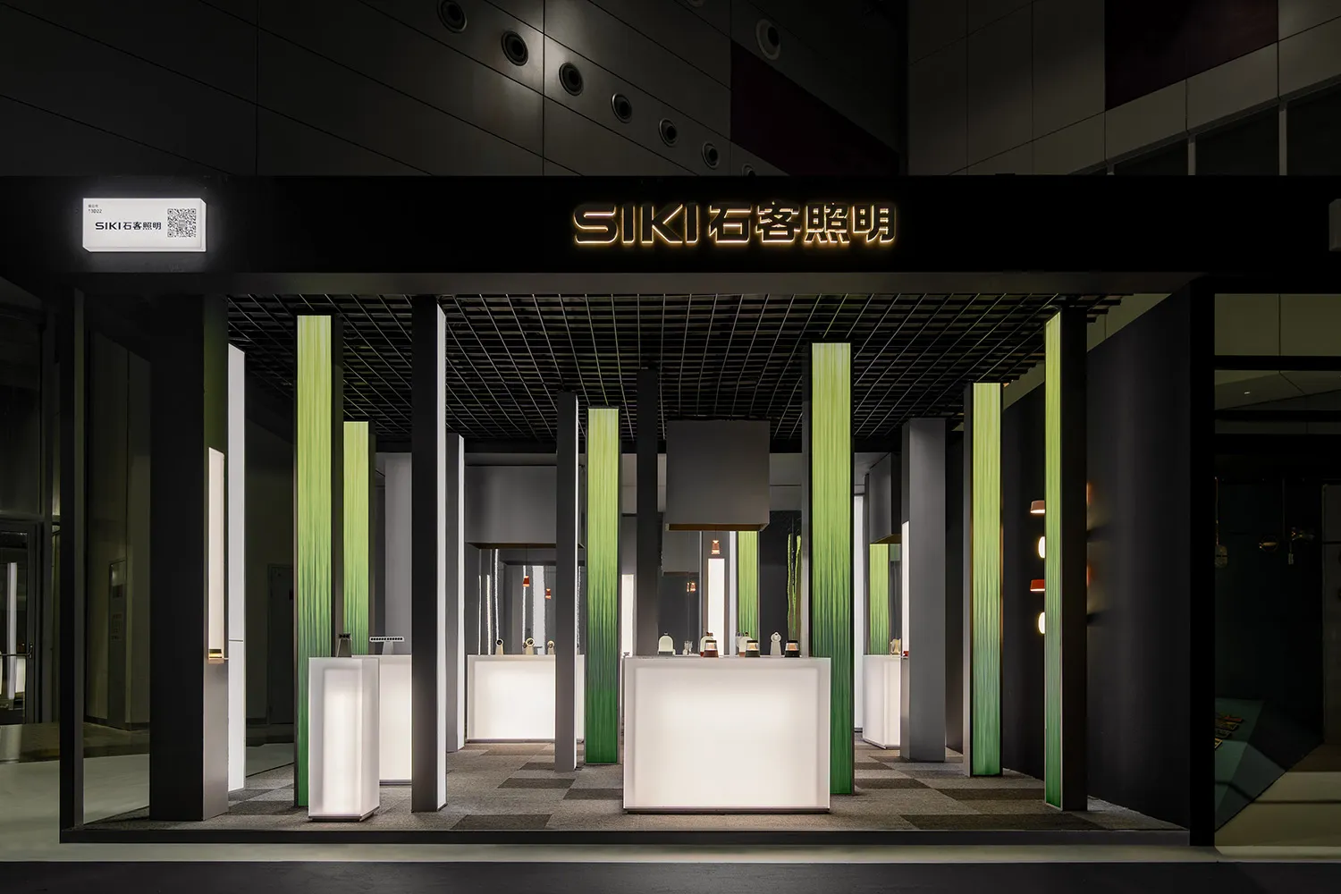 Modern retail storefront with sleek, minimalist design featuring black, green, and white kiosks.