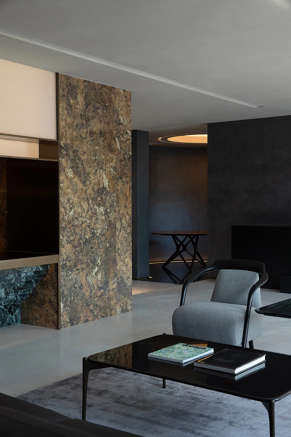 Modern living room featuring granite flooring and minimalist design elements.