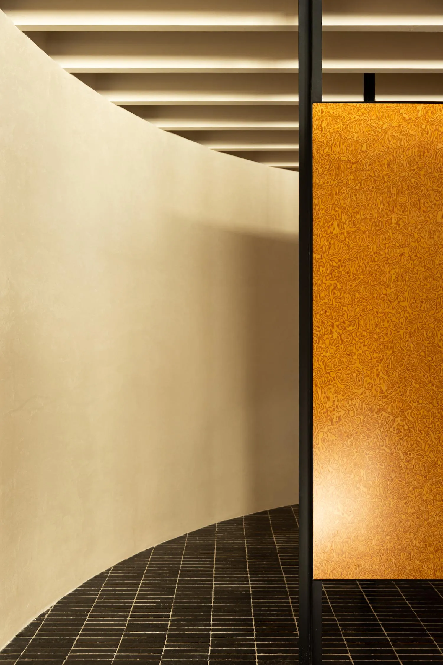 A minimalist interior design featuring a wooden panel wall.